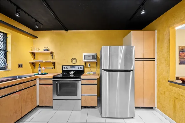 a kitchen with a refrigerator and a sink