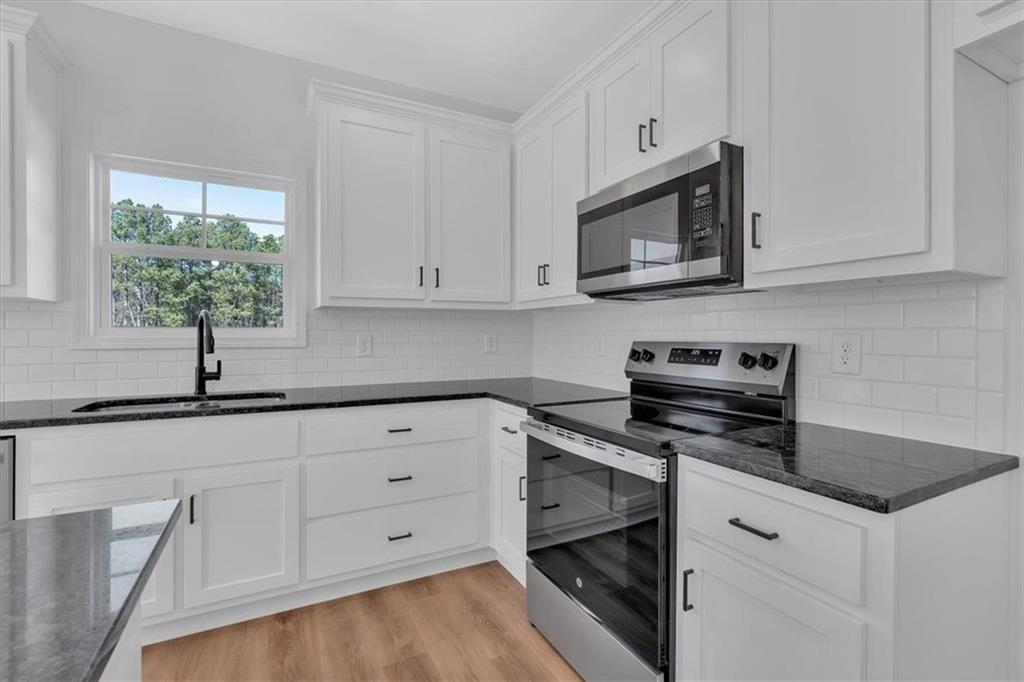 42 Dogwood Street Northeast Rome, GA 30161 - Photo 19 of 34 a kitchen with white cabinets and appliances
