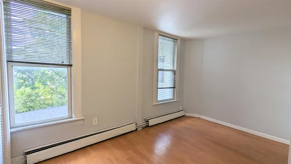 a view of a room with wooden floor