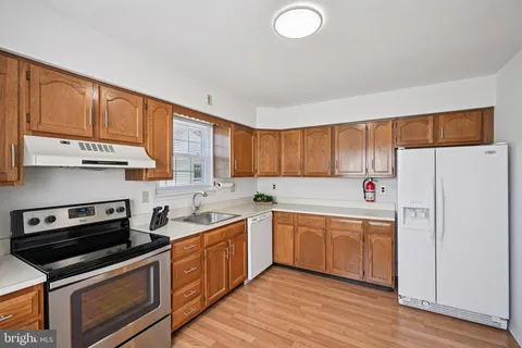 a kitchen with a sink stove and refrigerator