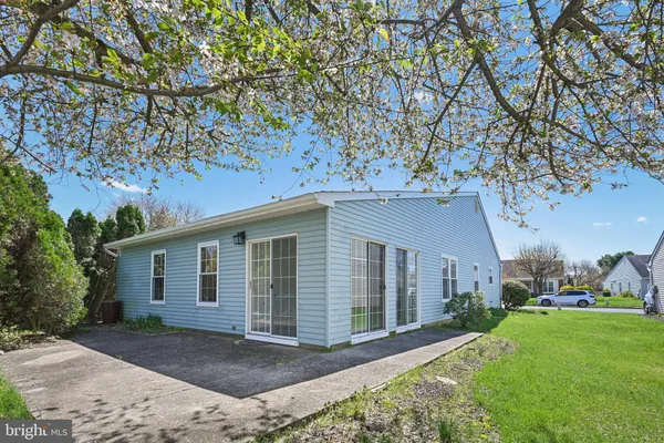 a front view of a house with a garden and yard