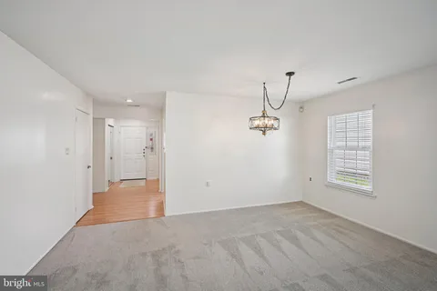 a view of a room with a window and a ceiling fan
