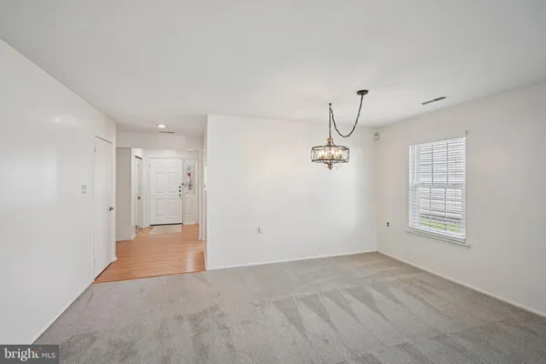 a view of a room with a window and a ceiling fan