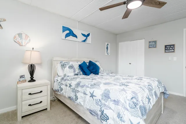 a bedroom with a bed and a lamp