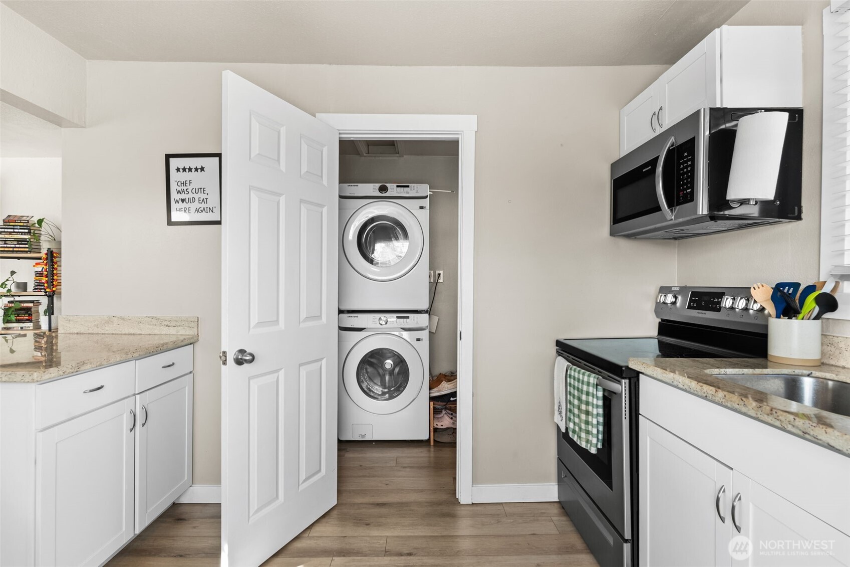 2719 South 70th Street Tacoma, WA 98409 - Photo 13 of 40 a kitchen with stainless steel appliances granite countertop a stove a microwave and cabinets