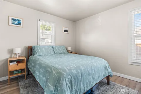 a bed sitting in a bedroom next to a window