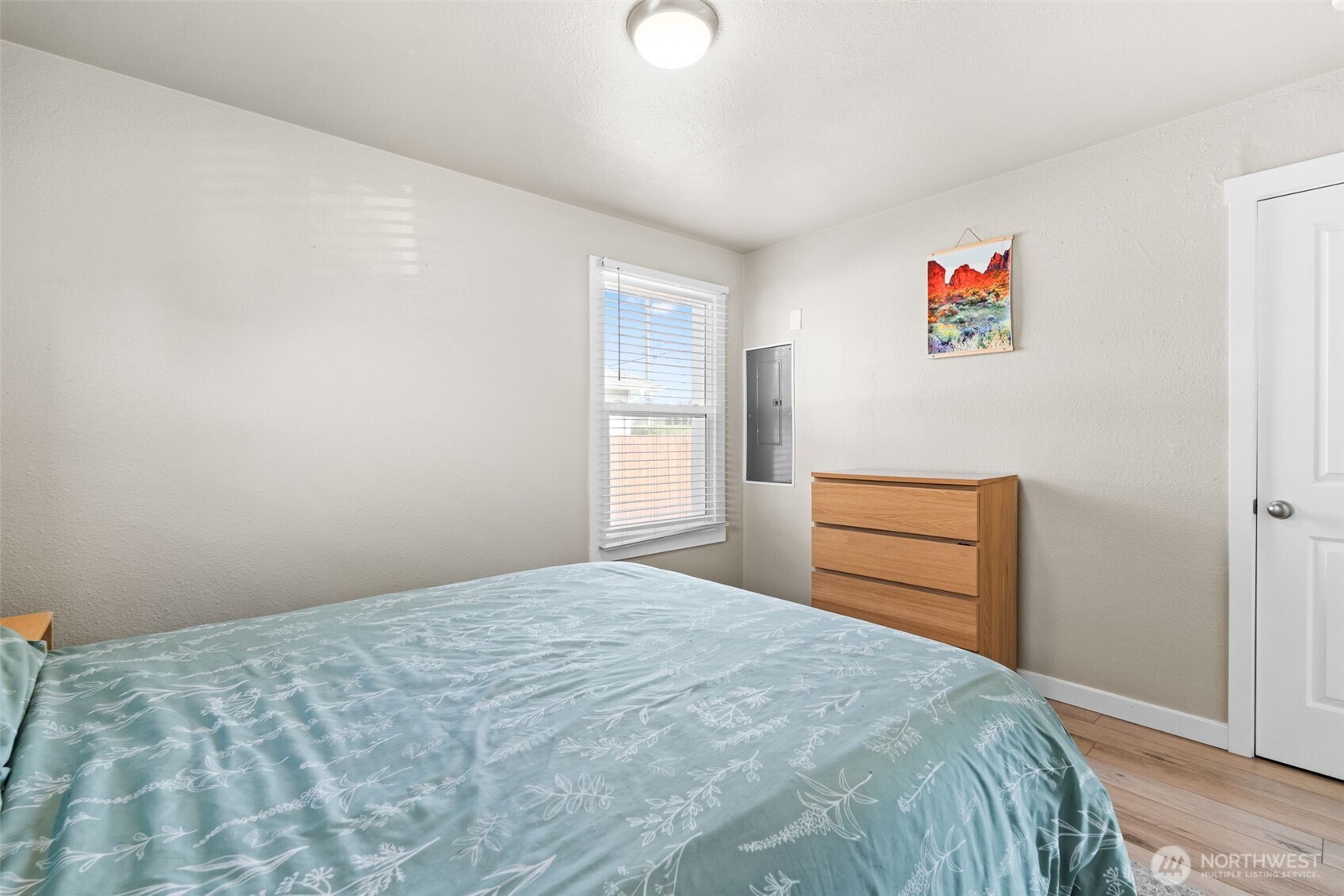 2719 South 70th Street Tacoma, WA 98409 - Photo 16 of 40 a bedroom with a bed and a cabinets