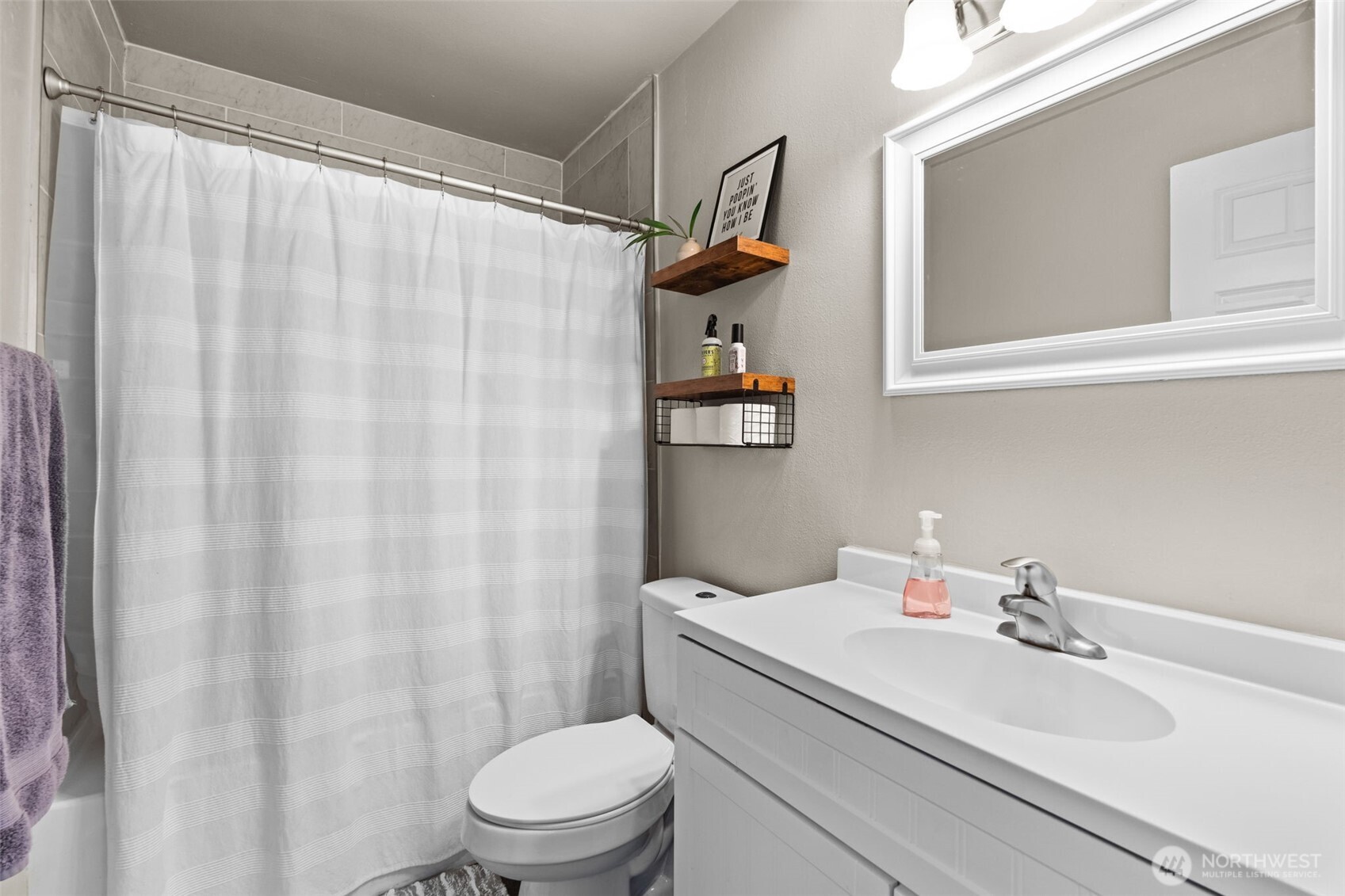 2719 South 70th Street Tacoma, WA 98409 - Photo 18 of 40 a bathroom with a sink a toilet and shower curtain