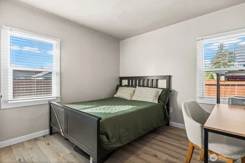 a bed sitting in a bedroom next to a window