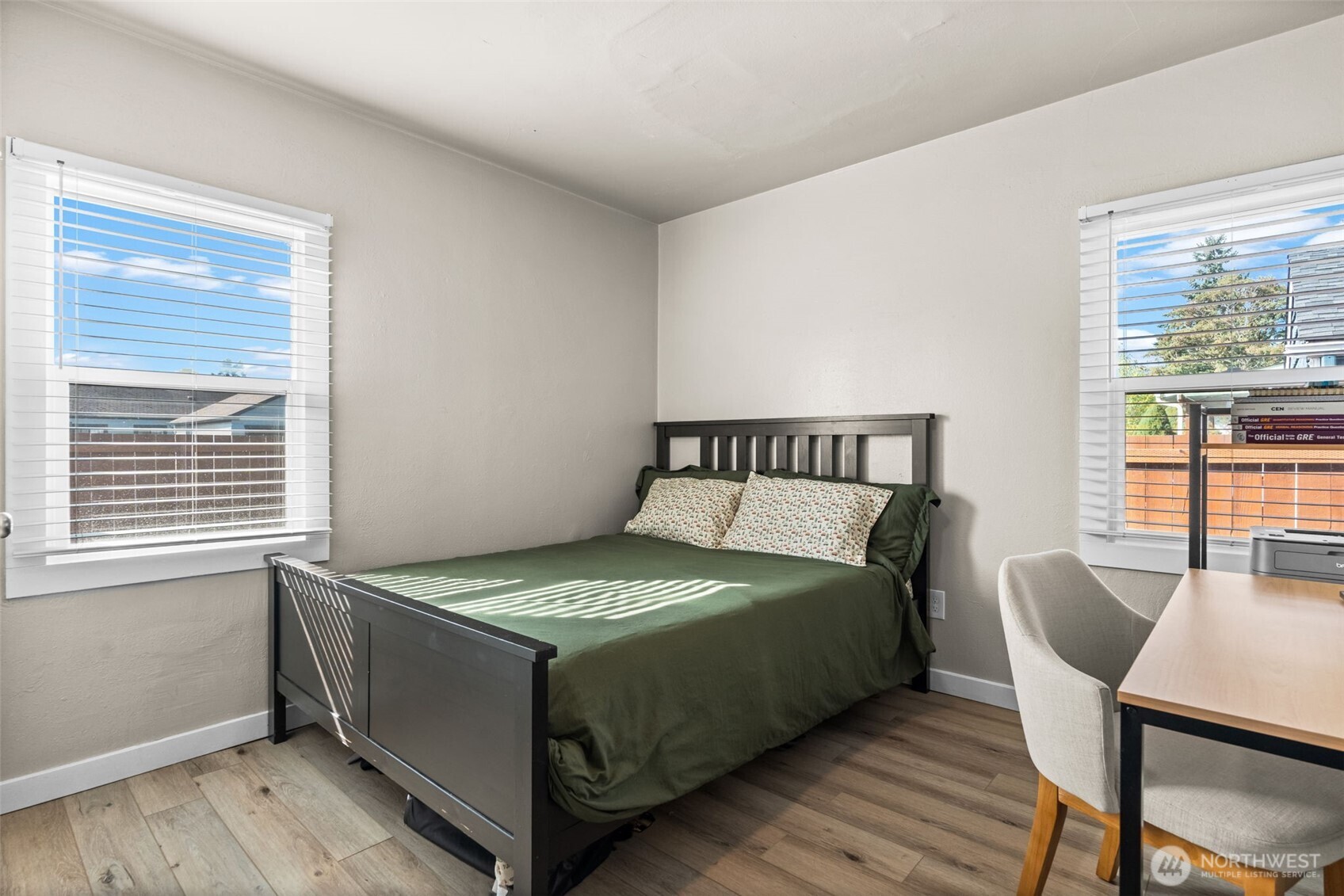 2719 South 70th Street Tacoma, WA 98409 - Photo 20 of 40 a bed sitting in a bedroom next to a window