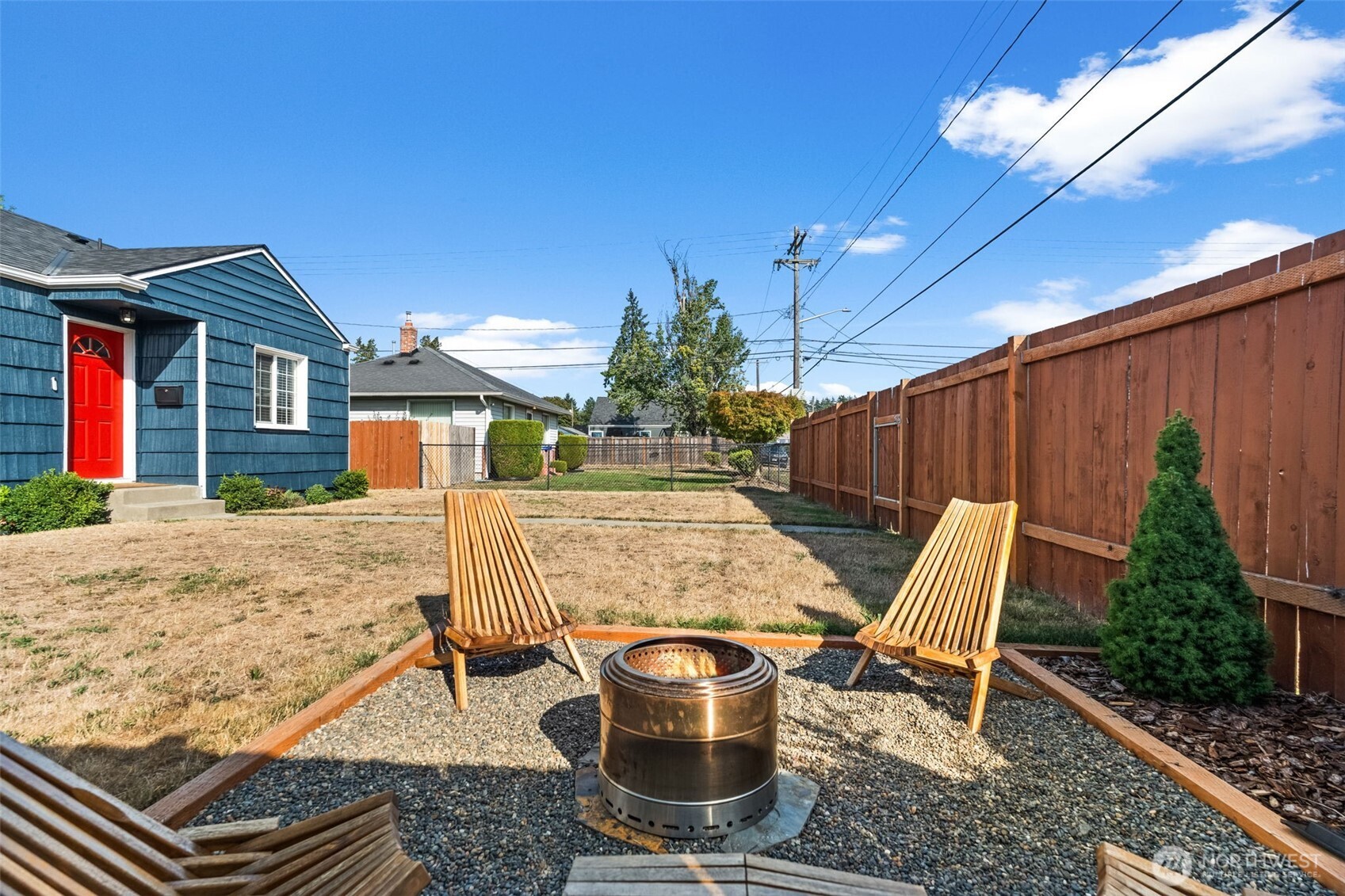 2719 South 70th Street Tacoma, WA 98409 - Photo 28 of 40 a view of a patio with table and chairs potted plants with wooden floor