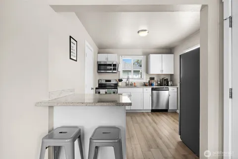 a kitchen with cabinets a sink and appliances