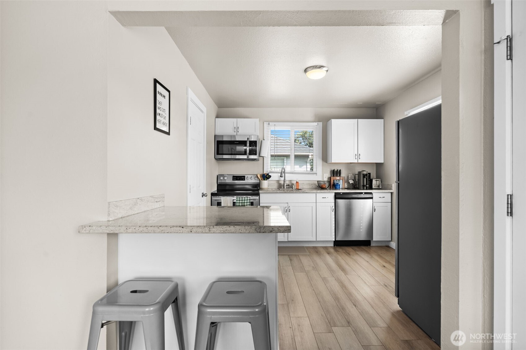 2719 South 70th Street Tacoma, WA 98409 - Photo 8 of 40 a kitchen with cabinets a sink and appliances