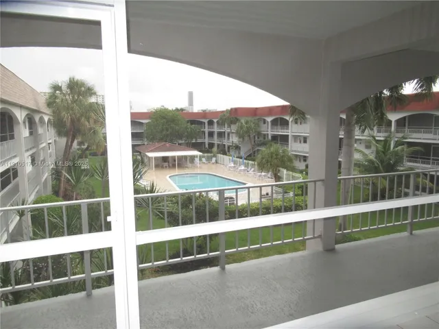 a view of balcony with mountain view and wooden floor