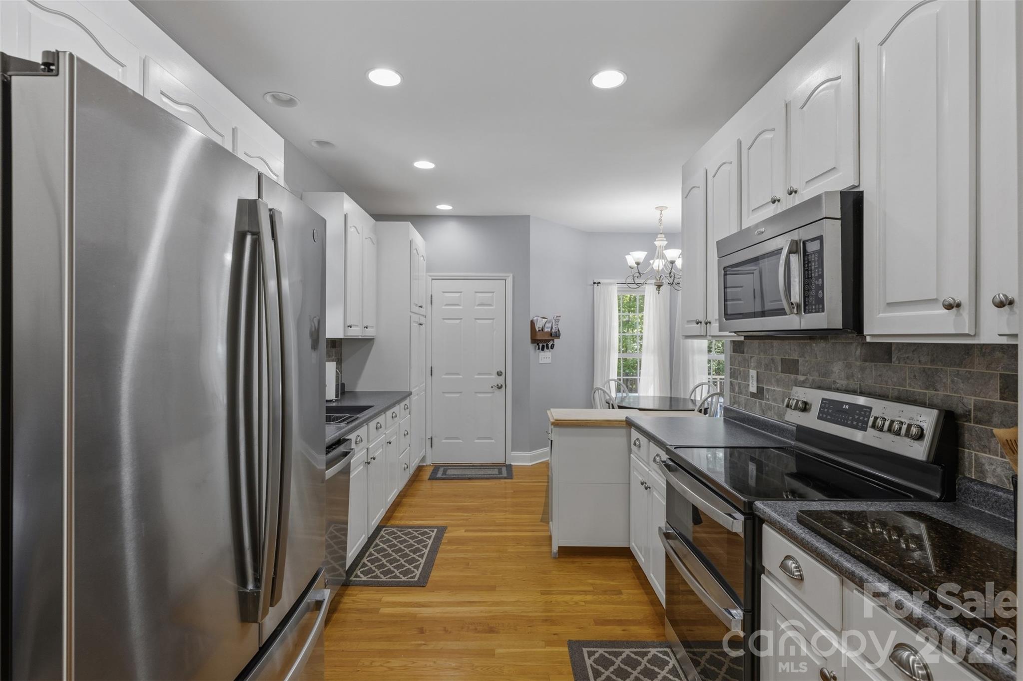 710 Sleepy Hollow Road Midland, NC 28107 - Photo 8 of 29 a kitchen with stainless steel appliances granite countertop a refrigerator a stove and a sink