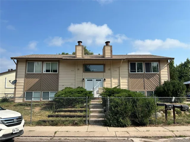 a view of a house with yard and sitting area