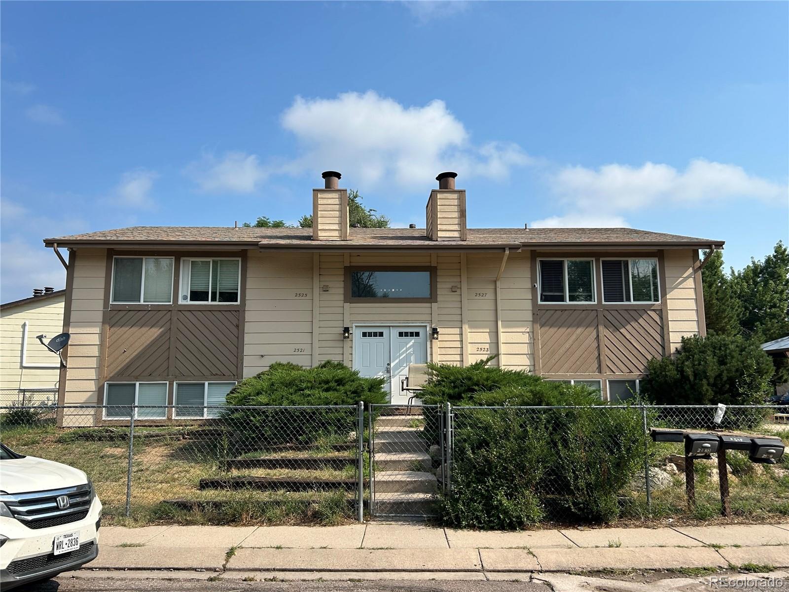 a view of a house with yard and sitting area