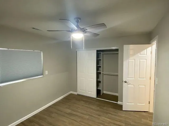 a view of an empty room with wooden floor