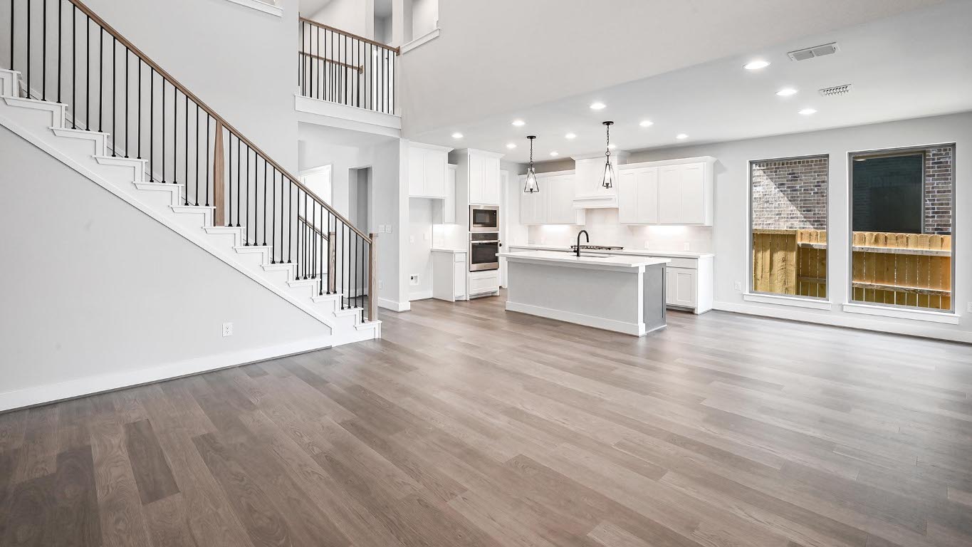 368 Prickly Poppy Loop Kyle, TX 78640 - Photo 20 of 39 Unfurnished living room featuring wood finished floors, stairs, a high ceiling, and recessed lighting