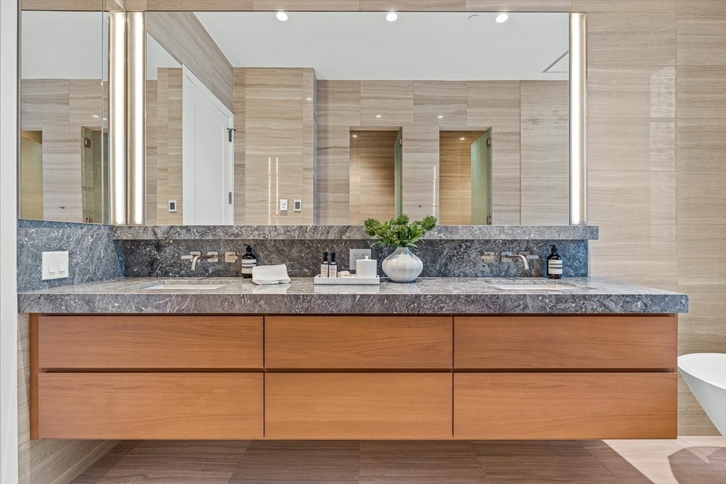40 Trinity Place, Unit PH35D Boston, MA 02116 - Photo 21 of 40 a bathroom with a granite countertop sink and a mirror