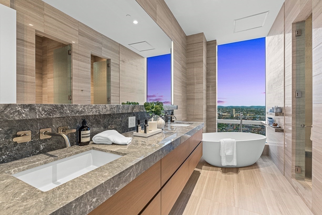 40 Trinity Place, Unit PH35D Boston, MA 02116 - Photo 22 of 40 a bathroom with a granite countertop tub sink and mirror