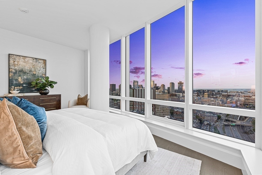 40 Trinity Place, Unit PH35D Boston, MA 02116 - Photo 23 of 40 a bedroom with a bed and a large window with balcony view