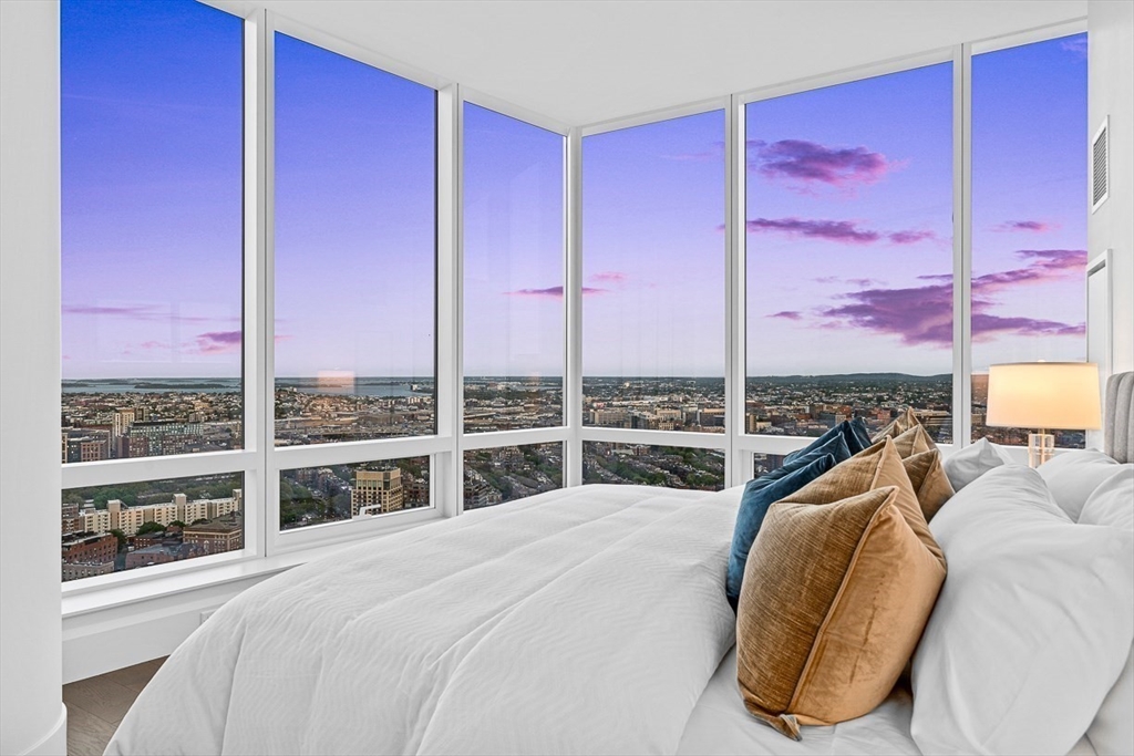 40 Trinity Place, Unit PH35D Boston, MA 02116 - Photo 24 of 40 a bed sitting in a bedroom next to a window