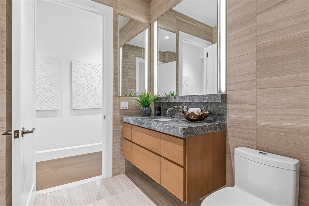 40 Trinity Place, Unit PH35D Boston, MA 02116 - Photo 34 of 40 a bathroom with a granite countertop sink a toilet and shower