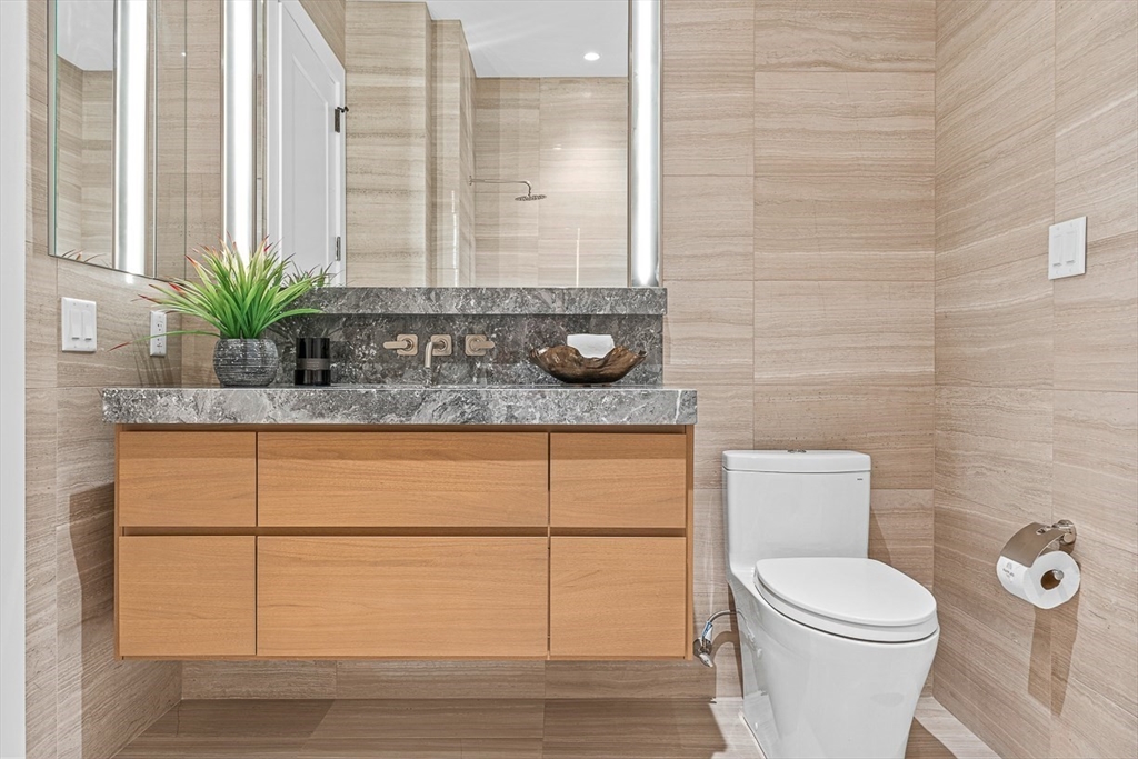 40 Trinity Place, Unit PH35D Boston, MA 02116 - Photo 37 of 40 a bathroom with a toilet a sink and mirror