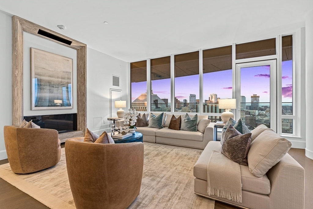 40 Trinity Place, Unit PH35D Boston, MA 02116 - Photo 6 of 40 a living room with furniture large windows and wooden floor