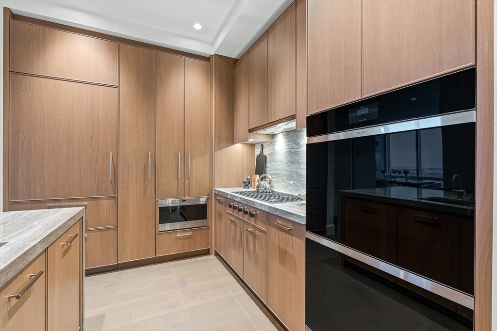 40 Trinity Place, Unit PH35D Boston, MA 02116 - Photo 9 of 40 a kitchen with a refrigerator and a stove