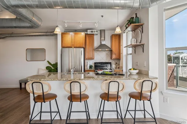 a kitchen with granite countertop a table chairs stove and cabinets