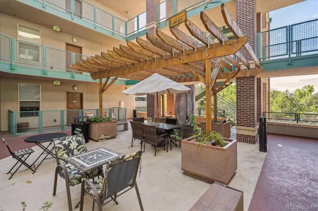 a view of a patio with couches table and chairs and potted plants