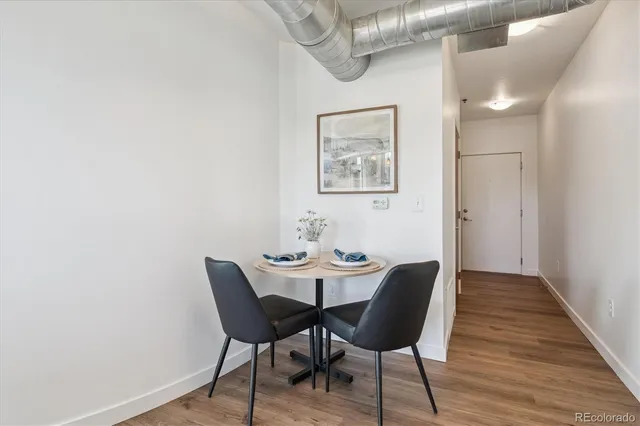 a view of a dining room with furniture and wooden floor