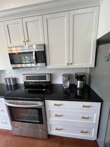 a kitchen with cabinets and appliances
