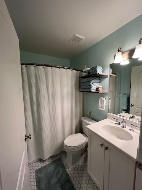 5270 Hyland Hills Avenue, Unit 1724 Sarasota, FL 34241 - Photo 13 of 35 a bathroom with a sink a toilet and shower