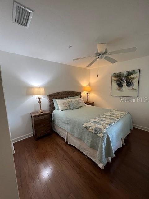 5270 Hyland Hills Avenue, Unit 1724 Sarasota, FL 34241 - Photo 14 of 35 a bedroom with a bed and a night stand