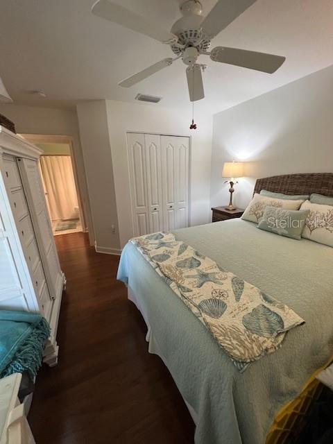 5270 Hyland Hills Avenue, Unit 1724 Sarasota, FL 34241 - Photo 16 of 35 a bedroom with a bed chandelier and a window