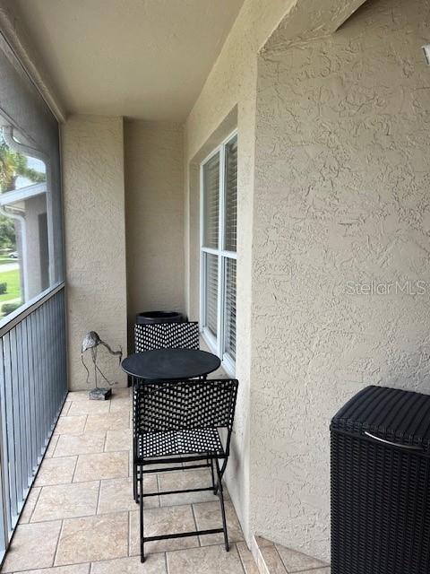 5270 Hyland Hills Avenue, Unit 1724 Sarasota, FL 34241 - Photo 2 of 35 a view of a balcony with wooden floor
