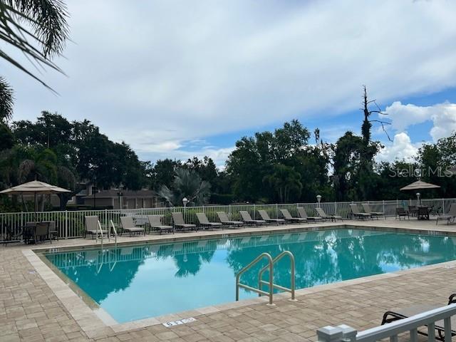 5270 Hyland Hills Avenue, Unit 1724 Sarasota, FL 34241 - Photo 26 of 35 a view of yard with swimming pool and outdoor seating