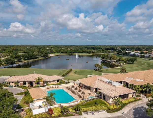 an aerial view of a house with outdoor space and lake view in back