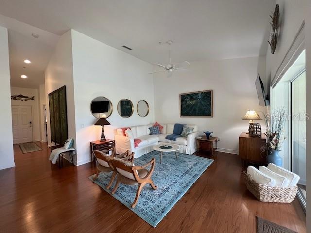5270 Hyland Hills Avenue, Unit 1724 Sarasota, FL 34241 - Photo 3 of 35 a living room with furniture and wooden floor