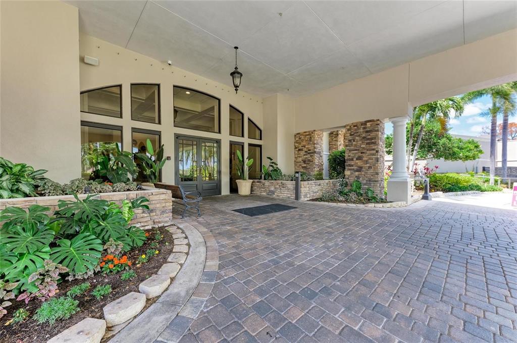 5270 Hyland Hills Avenue, Unit 1724 Sarasota, FL 34241 - Photo 33 of 35 a front view of a building with garden