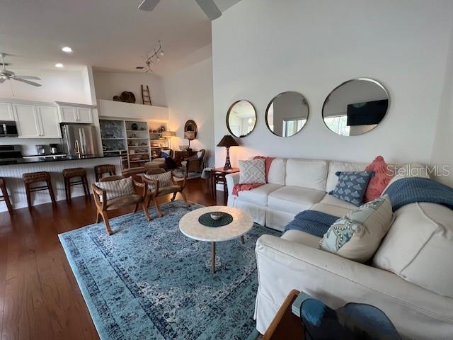 5270 Hyland Hills Avenue, Unit 1724 Sarasota, FL 34241 - Photo 4 of 35 a living room with furniture a rug and kitchen view
