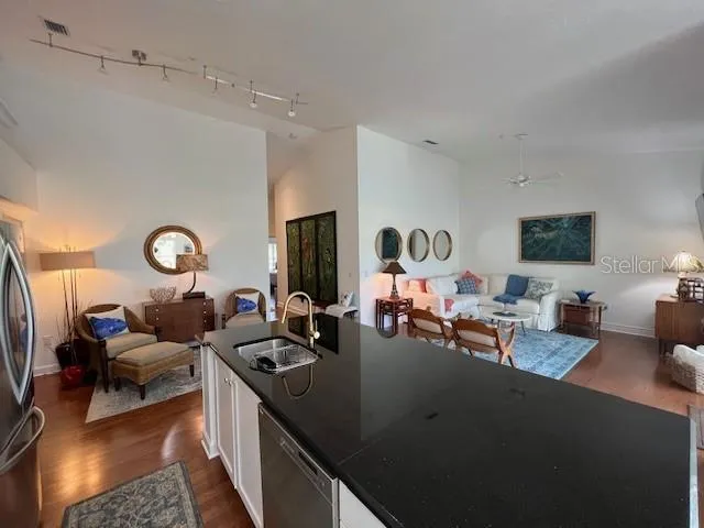 a living room with furniture a flat screen tv and a window