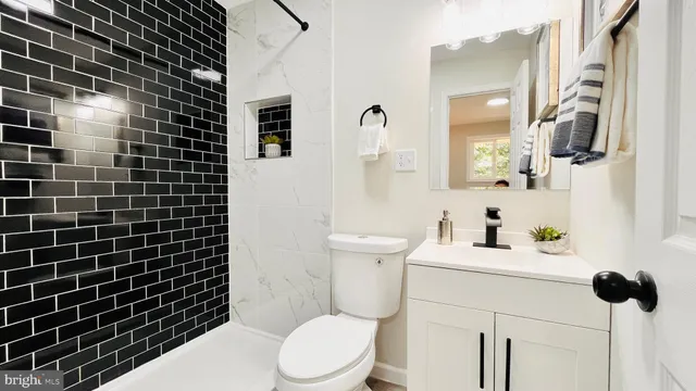 a bathroom with a toilet a sink and mirror