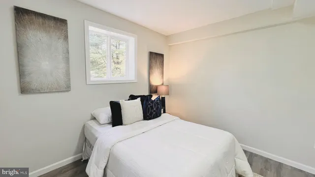 a bedroom with a bed and window