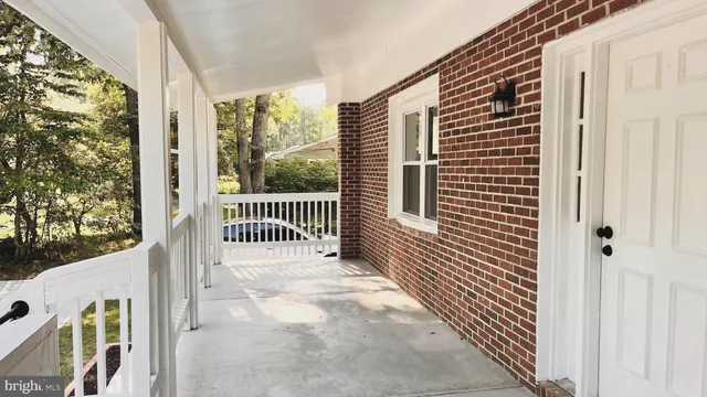 a view of a balcony with wooden floor and fence