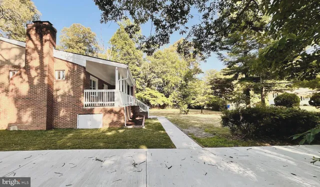 a view of a yard with wooden fence