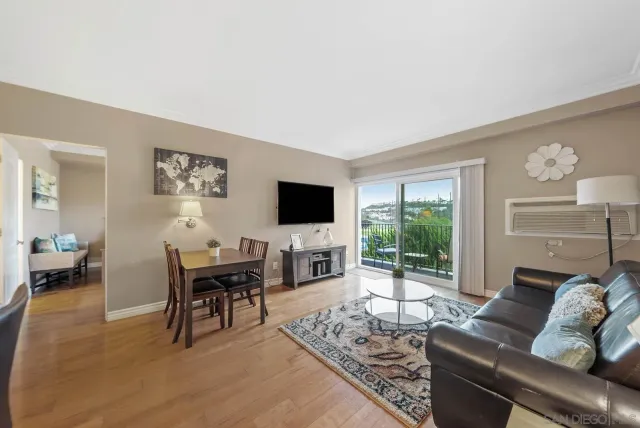 a living room with furniture a flat screen tv and a large window